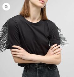 Lightweight viscose blend jersey crewneck top features beaded fringe at the sleeves. Easy fit, short sleeves, hem hits at hip. Elevate your easy black top outfit in 0 seconds flat. Black Top Outfit, Black Fringe Top, Fringe Tee, Fringe Shirt, Country Style Outfits, Bearded Lady, Fringe Top, Top Outfit, Beaded Top