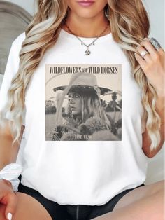 Welcome to EliteZCo, your ultimate destination for top-quality, music-inspired apparel right here on Etsy! Introducing our latest addition - the Lainey Wilson "Wild Horses" official fan club t-shirt. Crafted for fans who appreciate both comfort and style, this exclusive piece features a stylish front design with Lainey Wilson's name, while the back proudly displays "Wild Horses. Official Lainey Wilson Fan Club," ensuring you stand out as a dedicated fan. Indulge in ultimate comfort with our t-sh Summer Music-themed Shirt With Screen Print, Summer Graphic Tee With Band Logo, Graphic Tee For Spring Country Concerts, Letter Print Tops For Fall Music Festival, Letter Print Top For Fall Music Festival, Sublimation Print Tops For Summer Concert, Summer Tops With Sublimation Print For Concerts, Band Merch Tops For Country Concerts, Summer Concert Tops With Band Logo