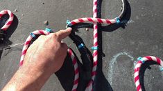 someone is holding onto the handlebars on their bike with red, white and blue rope