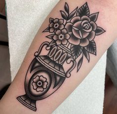 a black and white photo of a vase with flowers on it's side arm