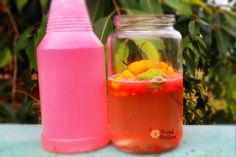 two jars filled with liquid sitting next to each other