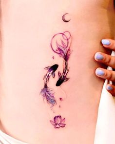 a woman's stomach with a tattoo design on the side of her belly and flowers