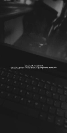 a black and white photo of a laptop with the caption texting on it