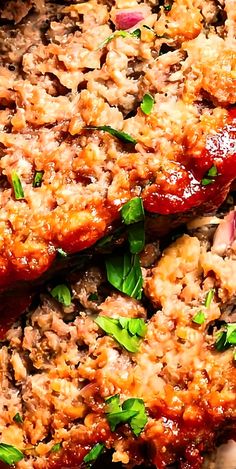 meatloaf covered in sauce and garnished with fresh herbs