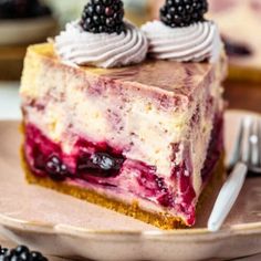 a piece of cake on a plate with blackberries