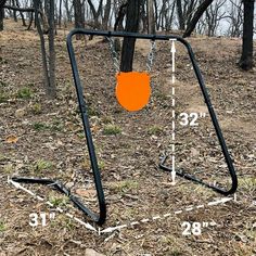 a swing set in the woods with measurements