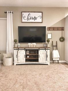 a living room filled with furniture and a flat screen tv on top of a wooden stand