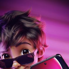 a young boy wearing sunglasses holding up a cell phone