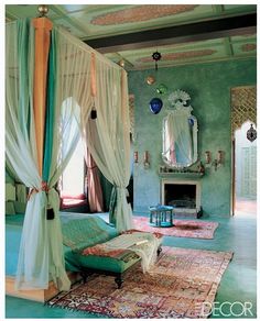 a bed room with a canopy and a rug on the floor in front of a fire place