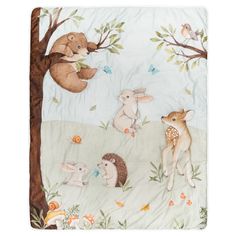 a blanket with animals and trees on it