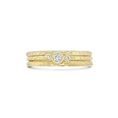 a gold ring with two diamonds on it