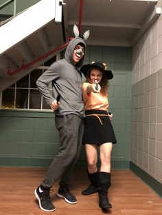 two people dressed in costumes posing for the camera