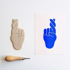 a stamp with a peace sign on it next to a piece of paper that has a hand print