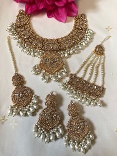 Beautiful elegant nauratan necklace set with white Pearl beads. Set includes necklace, earrings, tikka and jhumar. White Kundan Sets For Celebrations, White Bridal Sets With Stone Work For Party, White Bridal Sets With Tilla For Reception, Traditional White Bridal Sets For Reception, Festive White Chandbali Jewelry Sets, Festive White Jewelry Set With Intricate Design, White Bridal Chandbali Necklace With Intricate Design, White Chandbali Bridal Sets For Celebration, Traditional White Sets With Intricate Design