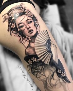 a woman with a fan tattoo on her thigh is shown in black and grey colors