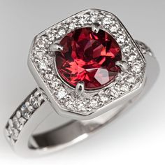 This elegant ring is centered with one (1) round modified brilliant cut natural tourmaline weighing 1.49 carats that is set into a four-prong setting. The tourmaline is bordered with twenty-four (24), bead set, round brilliant cut diamonds. The shoulders of the ring are each accented with four (4), bead set, round brilliant cut diamonds. The ring measures 11.5mm at the top, rises 7.1mm above the finger, tapering to 2.8mm wide and 1.5mm thick at the base of the shank. This ring is currently a size 4.5. Tourmaline Rings, Antique Cocktail Ring, Diamond Halo Ring, Bead Set, Tourmaline Ring, Halo Diamond Ring, Rings Jewelry, Elegant Ring, Vintage Jewels