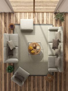 an overhead view of a living room with couches and coffee table