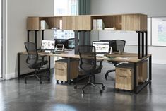 an office cubicle with two desks and chairs