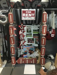 a room filled with football themed items and signs on the wall above it is a sign that says for rent