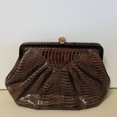 This Lyrella midcentury beauty is a classic perfect for an evening out or when you need a little bit of day time bling! In good vintage condition with no stains or marks on the interior. The interior zipper pocket works smoothly.   The is a little  wear on the very bottom of the clutch, please see photos for details. Dimensions in inches Width 9.5 Height 6 Depth 2.5 We offer free shipping in the US.  We are happy to combine shipping on international orders and cheerfully refund any shipping overages! Thank you for shopping with us. Vintage Brown Evening Bag For Party, Classic Brown Evening Bag For Formal Occasions, Classic Brown Formal Evening Bag, Vintage Brown Evening Bag, Brown Retro Clutch For Formal Occasions, Chic Brown Evening Bag For Formal Occasions, Retro Brown Clutch For Evening, Vintage Brown Clutch For Party, Chic Brown Clutch For Formal Occasions