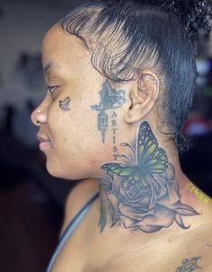 a woman with a butterfly tattoo on her neck