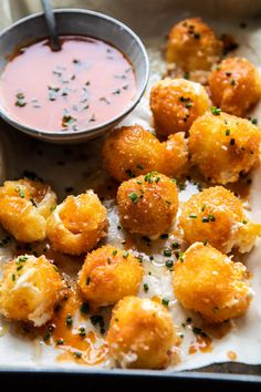 some fried food is on a plate with dipping sauce