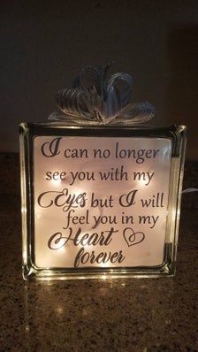 a lighted glass box with a poem on it that says i can no longer see you with my eyes but q will feel you in my heart