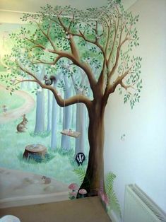 a child's room with a tree painted on the wall and radiator