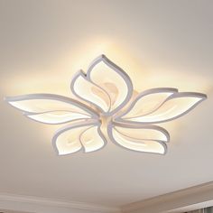 a living room with a large white flower on the ceiling