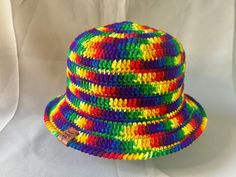 a multicolored hat is sitting on a white surface