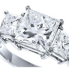 three stone engagement ring with princess cut diamonds on the shoulders and shoulder, set in white gold