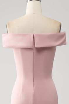 a pink dress on a mannequin dummy with an open back and zippers