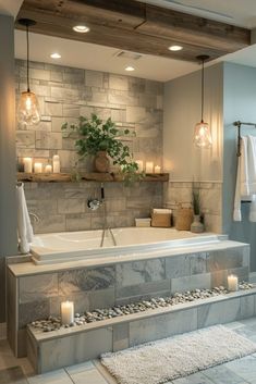 a bathroom with stone walls and flooring, candles on the bathtub next to it