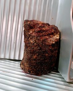 a large piece of food sitting on top of a metal shelf