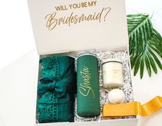 the bridesmaid gift box is filled with personalized items