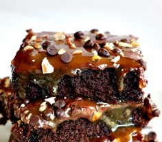 two pieces of chocolate cake with caramel drizzle and chocolate chips on top