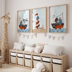 three framed pictures hang on the wall above a bench in a child's room