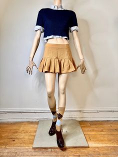 "I love this 90s pleated mini skirt. It looks so much like the Prada 2022 runway (see last pic). The skirt is a piquet textured tan skirt. It is fitted from the waist to the hip and then there are large pleats at the hip giving the skirt a lot of body. There is a side zip closure. The skirt is a mini skirt. It is in great condition. It is labeled a size 7/8. It is rayon and nylon but it has a cotton like look and feel. The sale is for the skirt only. The other items will be available in other li Fitted Preppy Tennis Skirt For Fall, Trendy Fitted Mini Hem Tennis Skirt, Fall Pleated Hem Skirt Skort, Fitted Tennis Skirt With Accordion Pleats For Fall, Fitted Cotton Skort With Ruffles, Fall Pleated Hem Skort, Mini Skirt With Pleated Hem, Cotton Pleated Tiered Mini Skirt, Cotton Mini Skirt With Pleated Hem