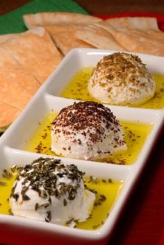 three desserts in small white dishes on a table