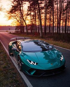 a green sports car is parked on the side of the road