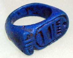 a blue ring with the word love written on it, sitting on a white surface