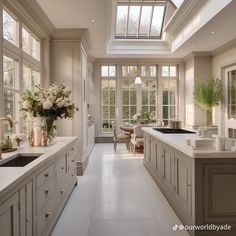 a large kitchen with an island and skylight in it's center window area