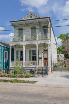 a two story house sitting on the corner of a street