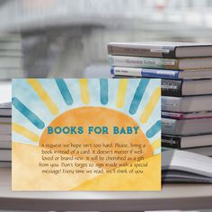 a stack of books sitting on top of a table next to a sign that reads books for baby