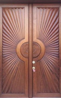 two wooden doors with intricate designs on them