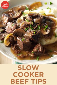 slow cooker beef tips on a plate with mashed potatoes and gravy