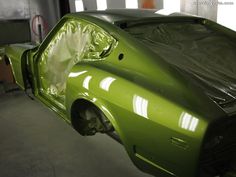 an image of a green car being worked on