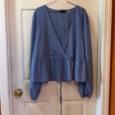 Pretty Little Thing Long Sleeves Blue Blouse In Us Size 16. It Has An Adjustable Waist And Elastic At The End Of The Sleeves. Material Is A 100% Polyester Aprox Measurements Laying Flat Pit To Pit 23 1/2” Length From Neck To Hem 26 1/2” Waist. 24” (Adjustable) 24”Would Be The Max Without Adjustment Sleeves Length 27 1/2” Smoke Free Home Light Blue Long Sleeve Blouse For Spring, Blue Blouse For Spring Brunch, Blue Blouse For Day Out In Fall, Light Blue Long Sleeve Blouse For Brunch, Light Blue Long Sleeve Blouse For Day Out, Light Blue Blouse For Fall Brunch, Light Blue Blouse For Brunch In Fall, Blue Tops For Workwear In Spring, Blue Tops For Workwear, Spring Season