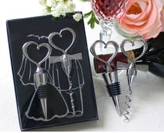 two wine bottle stoppers in the shape of bride and groom's dress on a table