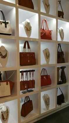 a display case filled with lots of different types of purses